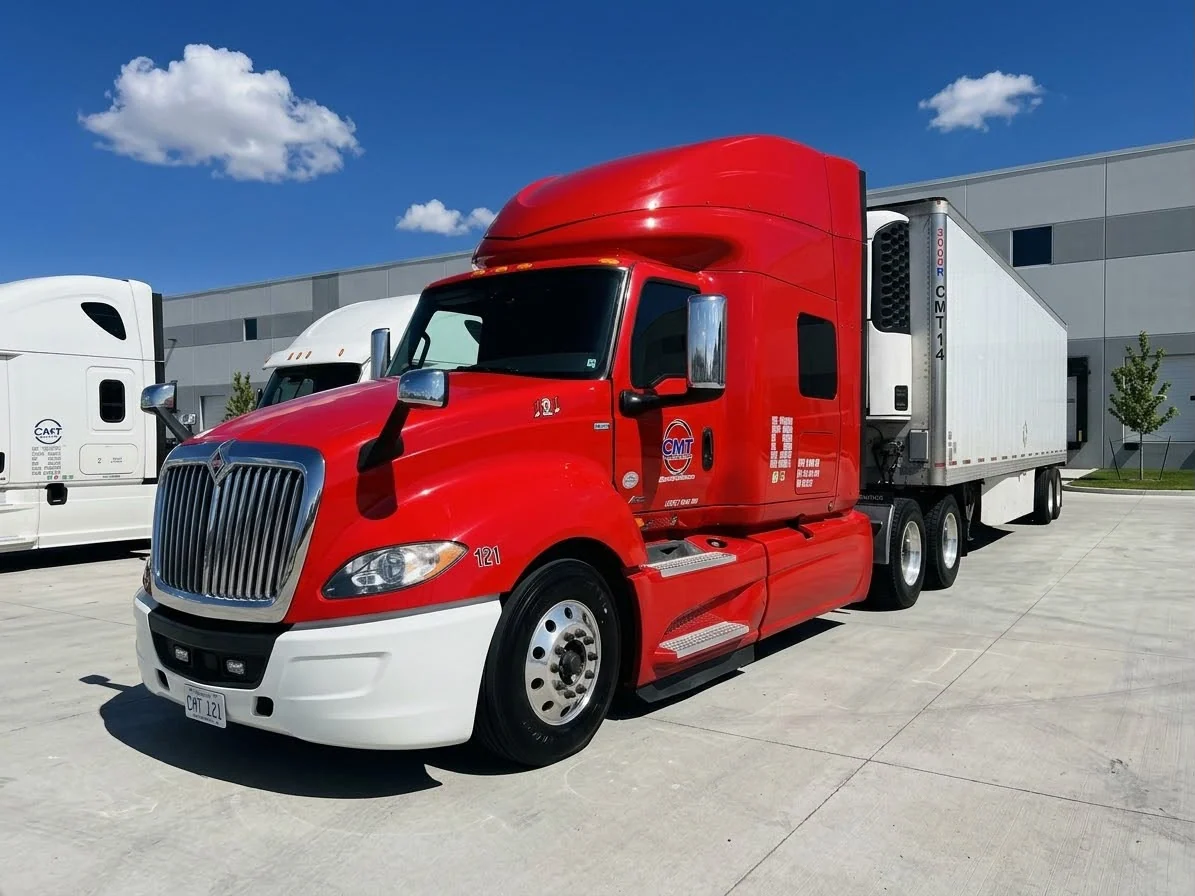 Red C M T Transport tractor connected to a refrigerated trailer