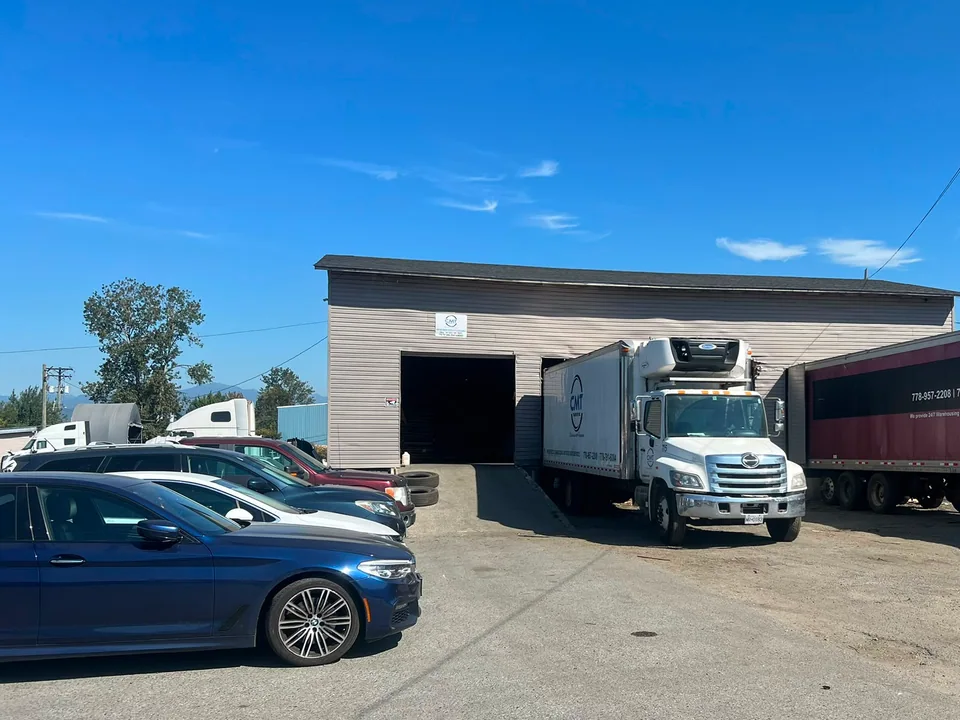 C M T Transport facility with a refrigerated straight truck at the warehouse