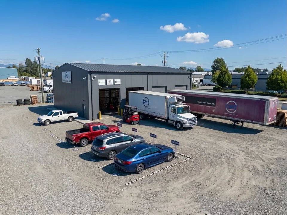 Aerial view of the C M T Transport operations yard, warehouse, trucks, and branded trailer