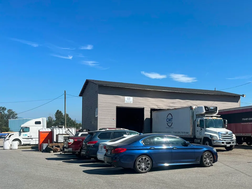 C M T Transport operations yard with warehouse, straight truck, and trailer