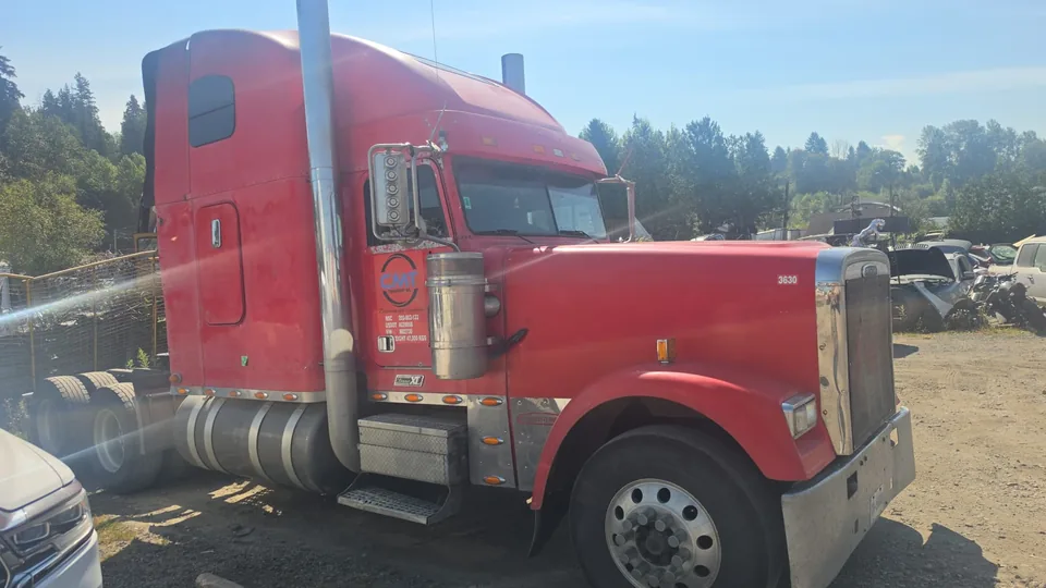 Side view of a red C M T Transport conventional highway tractor