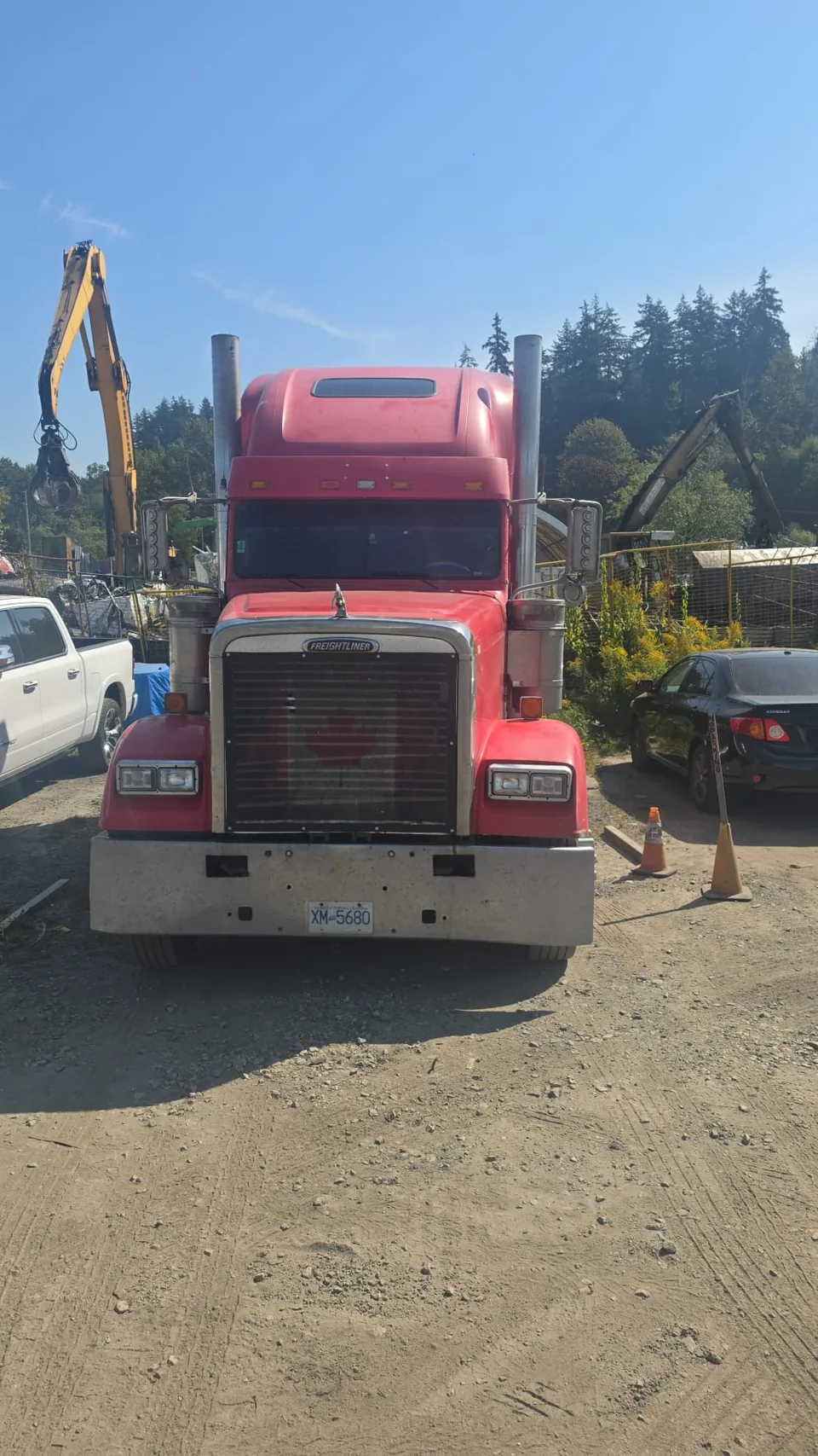 Front view of a red C M T Transport conventional highway tractor